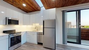 San Francisco apartment for rent - a kitchen with white cabinets and stainless steel appliances