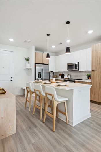 Stunning kitchens with quartz countertops, designer tile backsplash, soft-close cabinetry, and pantry storage