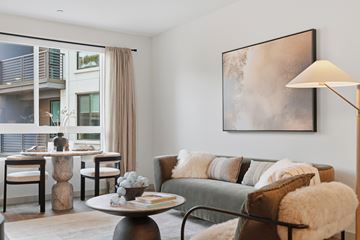 Encinitas apartment for rent - A living room with a grey couch, a coffee table, and a large painting on the wall.