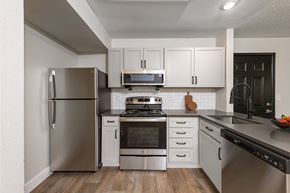 Westminster apartment for rent - A modern kitchen with stainless steel appliances and white cabinets.