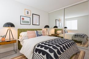 Vancouver apartment for rent - Bedroom with green upholstered headboard and mirrored closet at Brookside112 Apartments, Washington