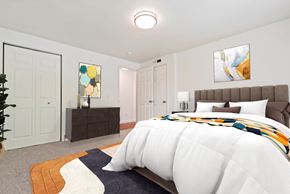 Boise apartment for rent - A bedroom with a large bed and a painting on the wall.