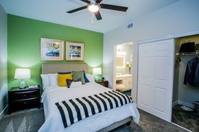 Las Vegas apartment for rent - A modern bedroom with a bed, nightstands, and ceiling fan at The Layne at Peccole Ranch modern apartments in Las Vegas.