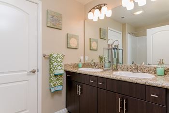 Dual sink with marble countertop in master bathroom