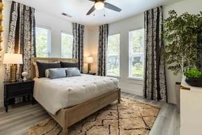 Charleston apartment for rent - A bedroom with a large bed and a ceiling fan.