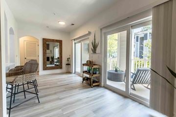 Charleston apartment for rent - A living room with a chair and a mirror.
