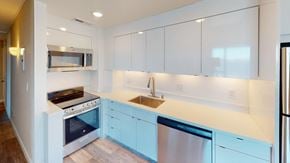San Francisco apartment for rent - a kitchen with white cabinets and blue countertops