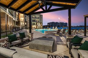 Celina apartment for rent - A poolside area with lounge chairs and a view of a residential building.