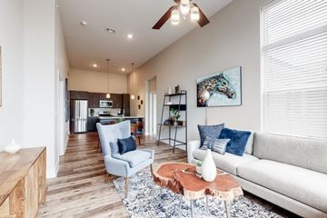 Lees Summit apartment for rent - A living room with a blue chair and a white couch.