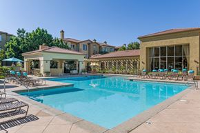 San Diego apartment for rent - A swimming pool with a sun lounger and a building in the background.