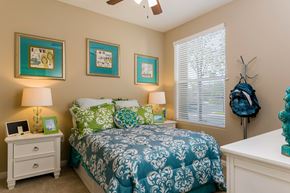 San Diego apartment for rent - A bedroom with a bed, nightstand, and three pictures on the wall.