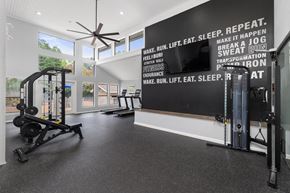 Chapel Hill apartment for rent - A gym with a wall of fitness related words and a row of exercise equipment.