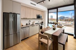 Nashville apartment for rent - a kitchen with stainless steel appliances and a wooden table
