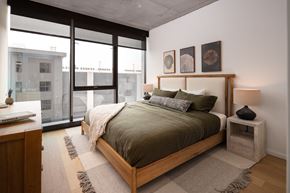 Nashville apartment for rent - a bedroom with a bed and a large window