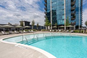 Nashville apartment for rent - a swimming pool with a large building in the background