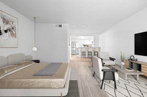 Phoenix apartment for rent - A modern bedroom with a large bed and a television.