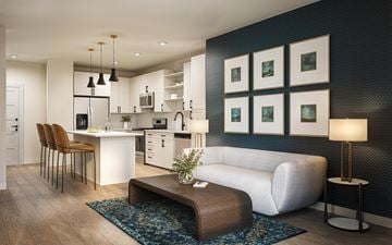 Morrisville apartment for rent - A modern kitchen with a white island and a white sofa.