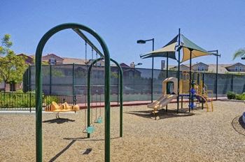 A playground with a swing set and a slide.