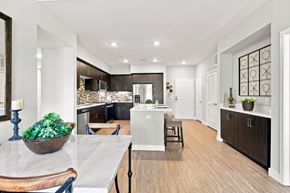 San Diego apartment for rent - A modern kitchen with a marble countertop and wooden flooring.
