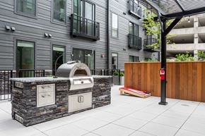 1014 Spurce St apartment for rent - A modern outdoor kitchen area with a stone counter and a built-in oven.
