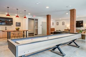 1014 Spurce St apartment for rent - A shiny pool table is in the middle of a room with a bar and a TV.