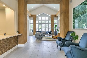 Boise apartment for rent - A living room with a grey sofa and a wooden floor.