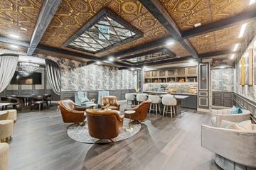 Scottsdale apartment for rent - a living room with chairs and a bar and a mirrored ceiling