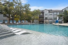 Leander apartment for rent - A large swimming pool with steps leading into the water.