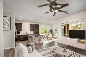 Spring Valley apartment for rent - Living room with a ceiling fan and a kitchen in the background  at Lakeview 88, Spring Valley, CA