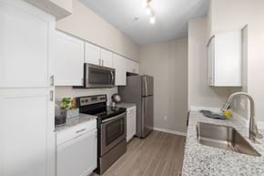 Raleigh apartment for rent - a kitchen with stainless steel appliances and granite counter tops