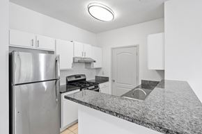 Durham apartment for rent - A kitchen with a granite countertop and stainless steel appliances.