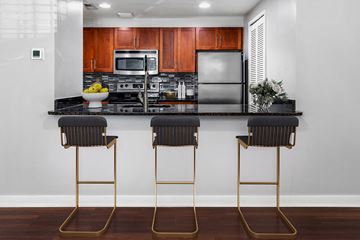Philadelphia apartment for rent - A kitchen with a black counter top and two black barstools.