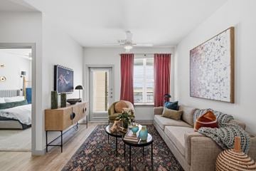 Prosper apartment for rent - A living room with a couch, a side table, a rug, and a painting on the wall.