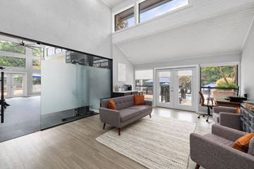 Chapel Hill apartment for rent - A living room with a grey couch and a glass wall.