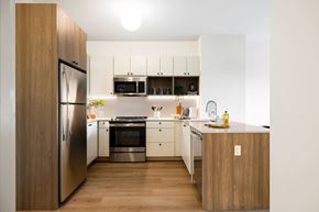 Jersey City apartment for rent - A modern kitchen with wooden cabinets and stainless steel appliances.