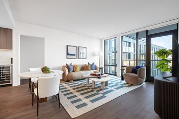 Washington apartment for rent - A living room with a white couch and a coffee table.