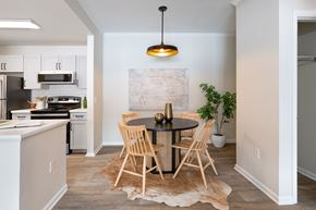Denver apartment for rent - A kitchen with a table and chairs in the middle of the room.