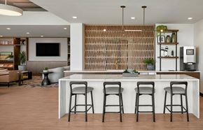 Phoenix apartment for rent - an indoor kitchen with a counter and three stools, coffee machine, ceiling lighting