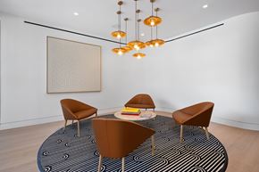 Raleigh apartment for rent - A seating area in the leasing office with a round table and chairs.