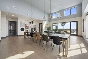 Houston apartment for rent - A modern dining room with a long table and chairs.