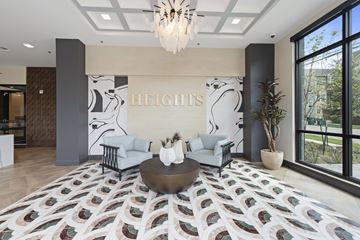Houston apartment for rent - A living room with a rug on the floor and a chandelier hanging from the ceiling.