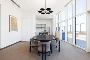 Vienna apartment for rent - A conference room with a table and chairs and a painting on the wall.