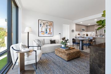 Washington apartment for rent - A living room with a white couch and a painting on the wall.