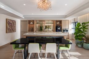 Washington apartment for rent - A modern dining room with a black table and green chairs.