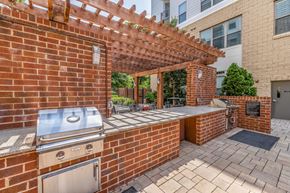 Raleigh apartment for rent - an outdoor kitchen with a barbecue and a pergola