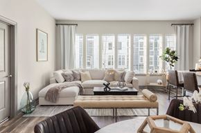 Ronkonkoma apartment for rent - A living room with a brown leather chair and a white sofa.