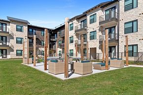Arlington apartment for rent - an apartment building with patio furniture and grass