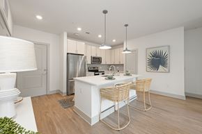 Mtpleasant apartment for rent - A modern kitchen with white cabinets and a wooden floor.