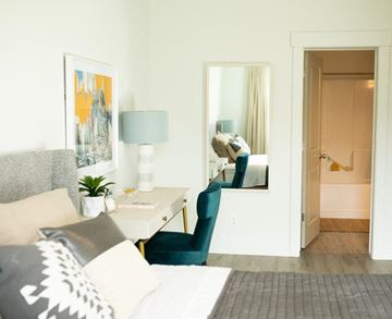 North Salt Lake apartment for rent - a living room with a couch and a desk and a mirror