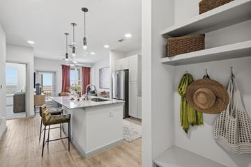 Prosper apartment for rent - A kitchen with a white counter and a stool.